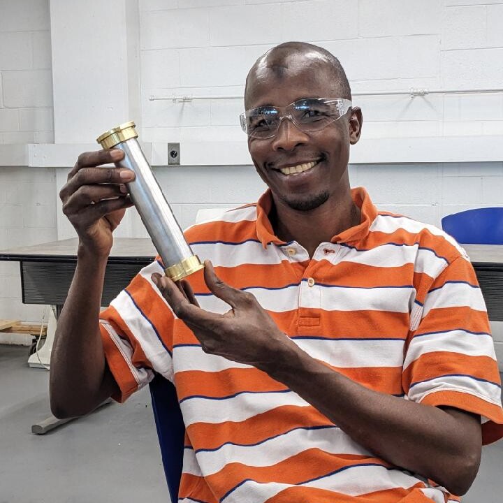 Machining student holding project from career skills class